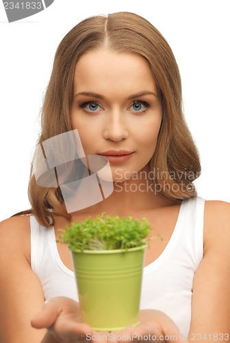 Image of woman with green grass in pot