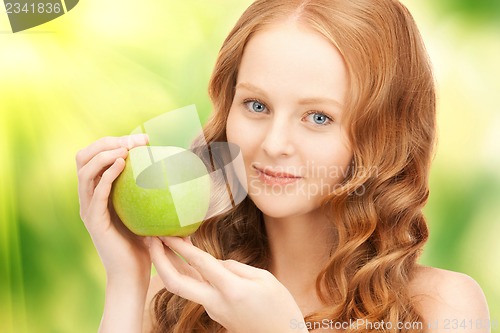 Image of young beautiful woman with green apple