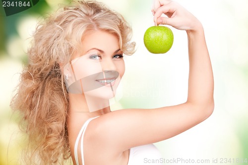 Image of young beautiful woman with green apple