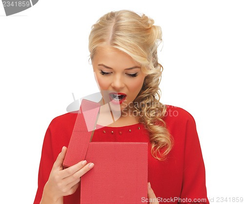 Image of lovely woman in red dress with opened gift box