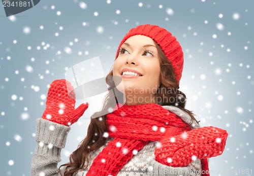 Image of beautiful woman in hat, muffler and mittens