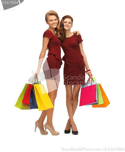 Image of teenage girls in red dresses with shopping bags