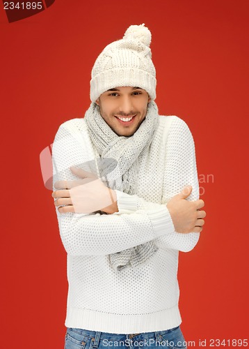 Image of handsome man in warm sweater, hat and scarf