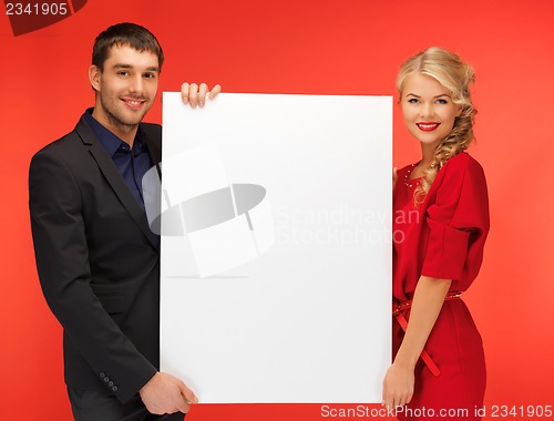 Image of couple holding big blank board