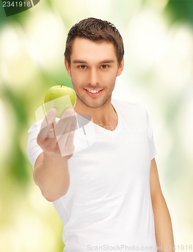 Image of man in white shirt with green apple
