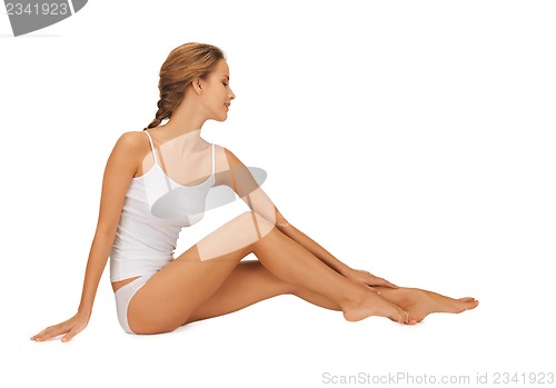 Image of woman in cotton undrewear touching her legs