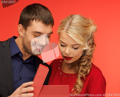 Image of man and woman looking inside the gift box