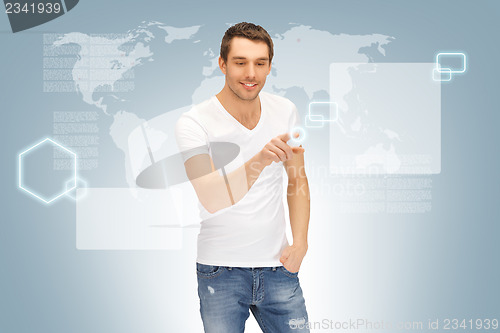Image of handsome man working with touch screen