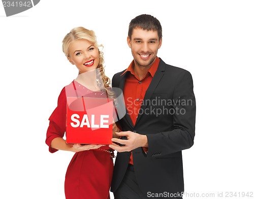 Image of man and woman with sale sign