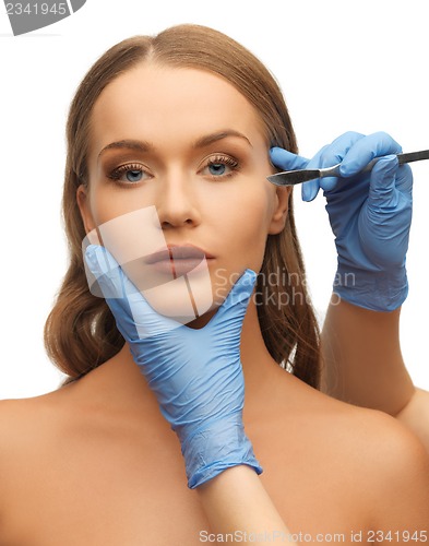 Image of woman face and beautician hands