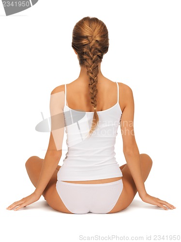 Image of woman in undrewear practicing yoga lotus pose