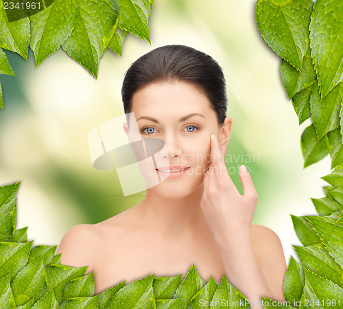 Image of beautiful woman with green leaves