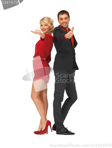 Image of handsome man and lovely woman showing thumbs up