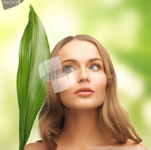 Image of woman with green leaf
