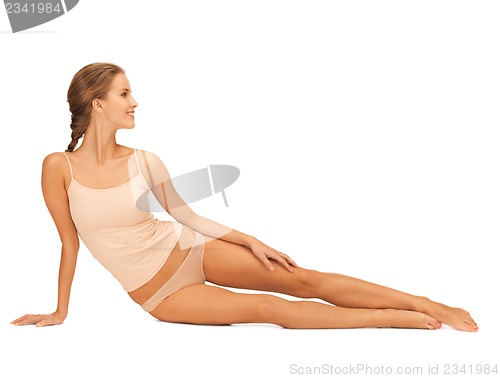 Image of woman in cotton underwear touching her legs