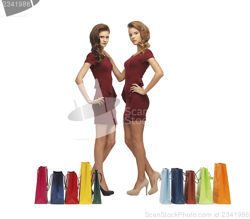 Image of teenage girls in red dresses with shopping bags