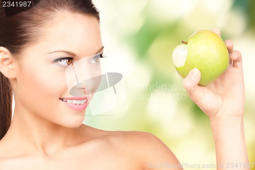Image of young beautiful woman with green apple