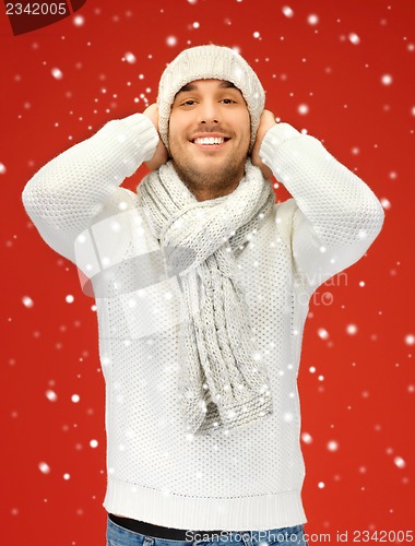 Image of handsome man in warm sweater, hat and scarf