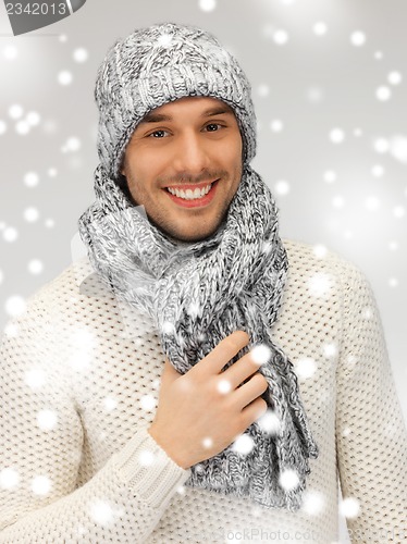 Image of handsome man in warm sweater, hat and scarf