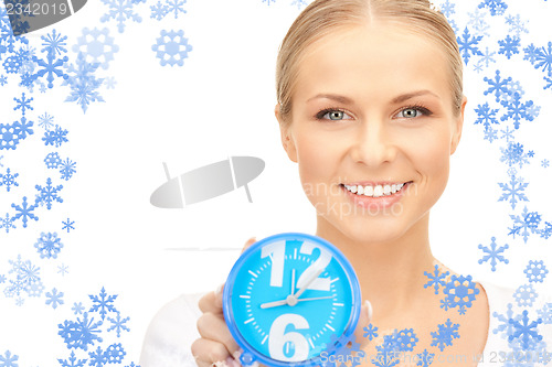Image of woman holding alarm clock