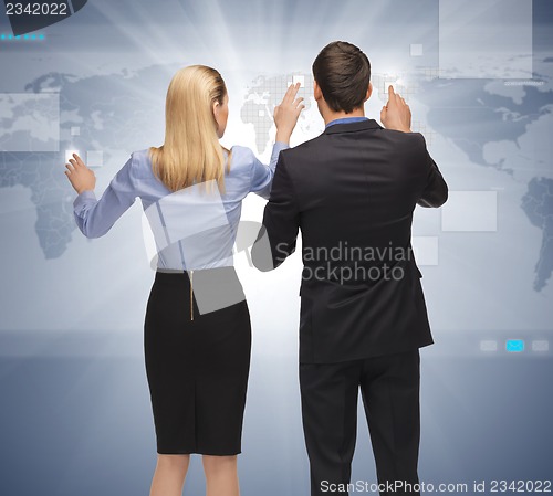 Image of man and woman working with something imaginary