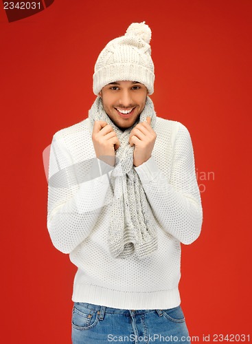 Image of handsome man in warm sweater, hat and scarf