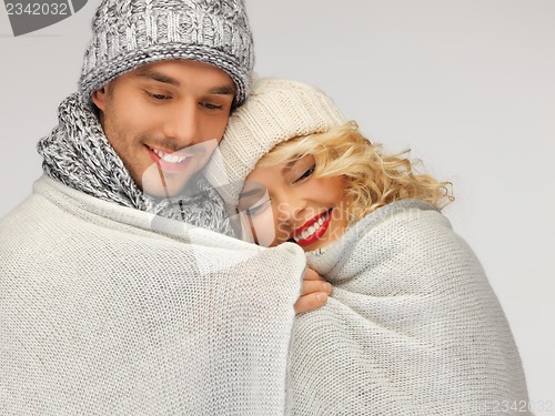 Image of family couple under warm blanket