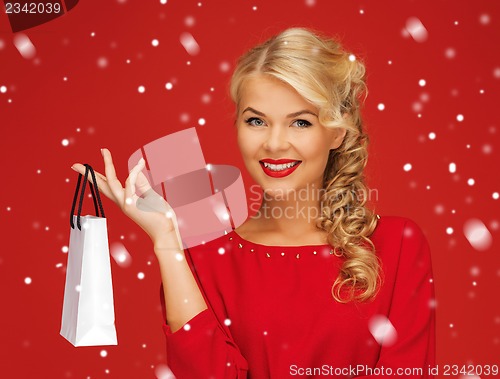 Image of lovely woman in red dress with shopping bag