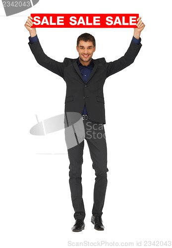 Image of handsome man in suit with sale sign