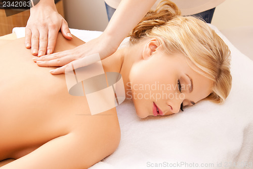 Image of beautiful woman in massage salon