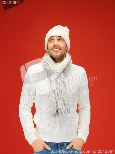 Image of handsome man in warm sweater, hat and scarf