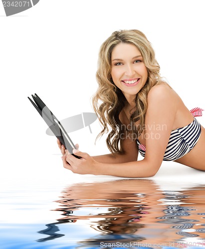 Image of woman in bikini with tablet pc computer