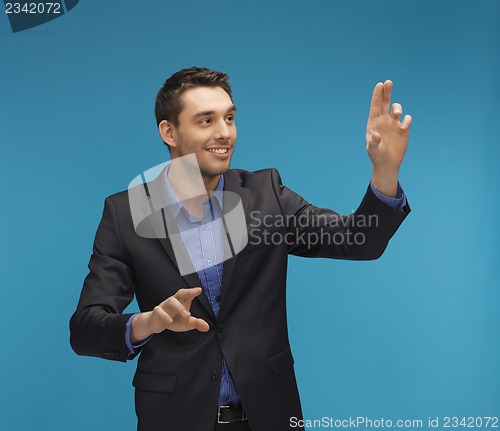 Image of man in suit working with something imaginary
