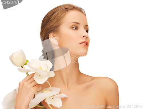 Image of lovely woman with orchid flower