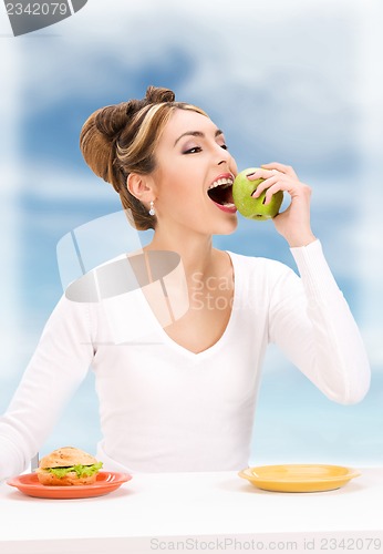 Image of woman with green apple and sandwich