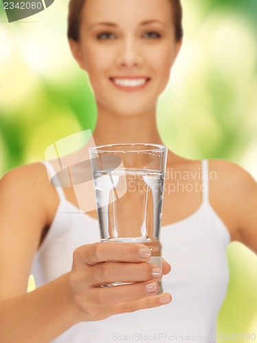 Image of woman hands holding glass of water