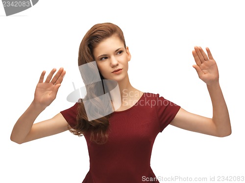 Image of girl in red dress working with something imaginary