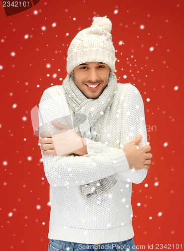 Image of handsome man in warm sweater, hat and scarf