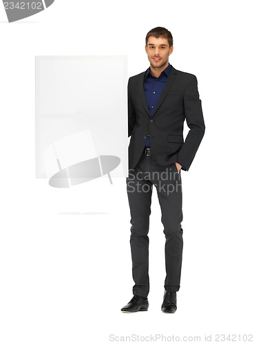 Image of handsome man in suit with a blank board