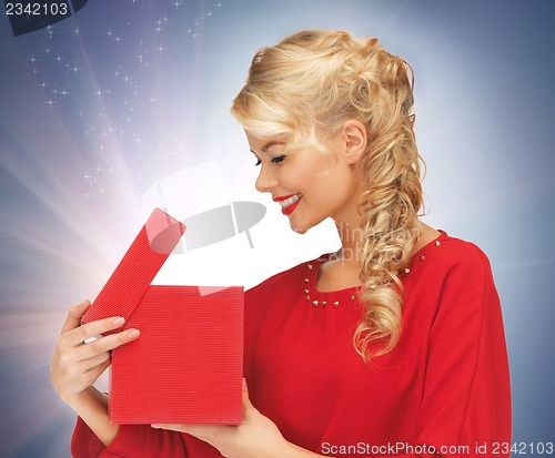 Image of lovely woman in red dress with opened gift box