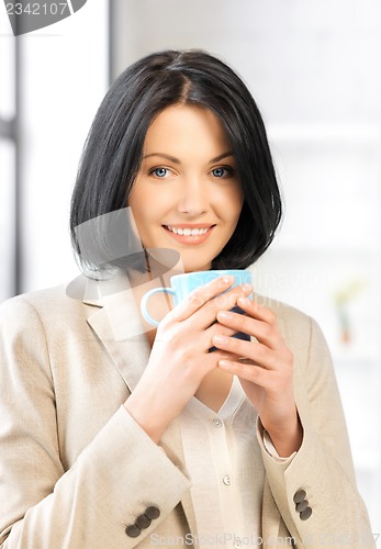 Image of lovely businesswoman with mug