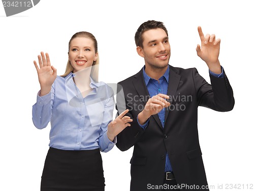 Image of man and woman working with something imaginary