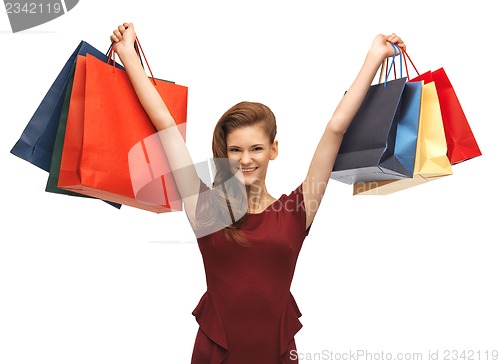 Image of teenage girl in red dress with shopping bags