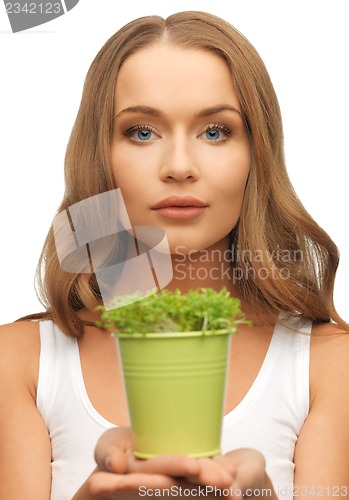 Image of woman with green grass in pot