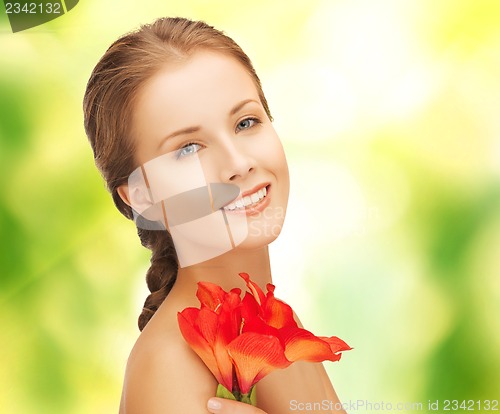 Image of beautiful woman with red lily flower