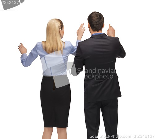 Image of man and woman working with something imaginary