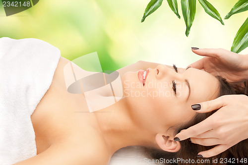 Image of beautiful woman in massage salon