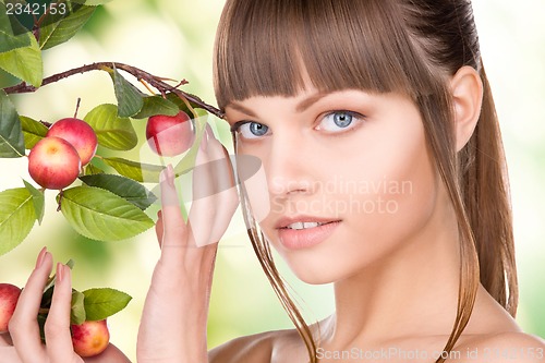 Image of lovely woman with apple twig