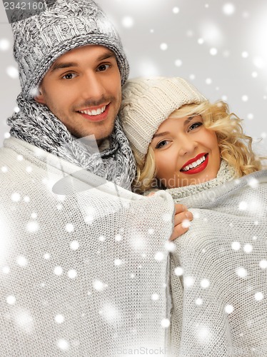 Image of family couple under warm blanket