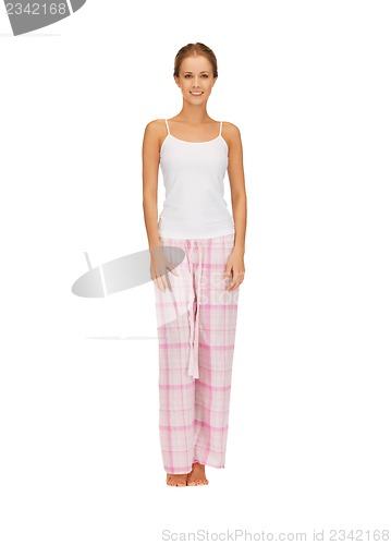 Image of happy and smiling woman in cotton pajamas